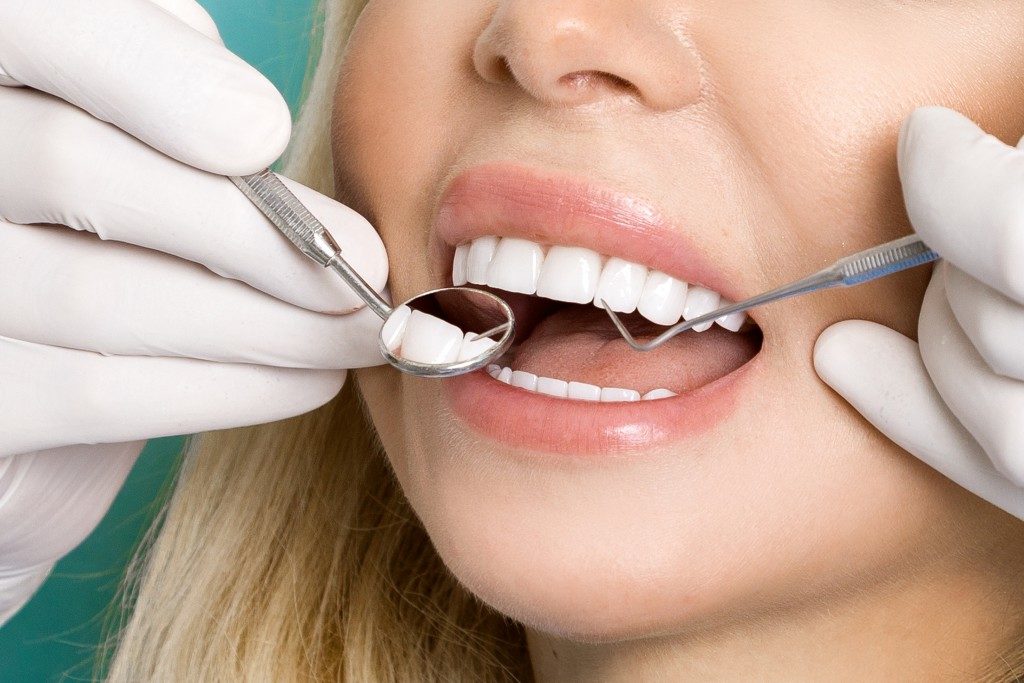 Woman having her teeth checked