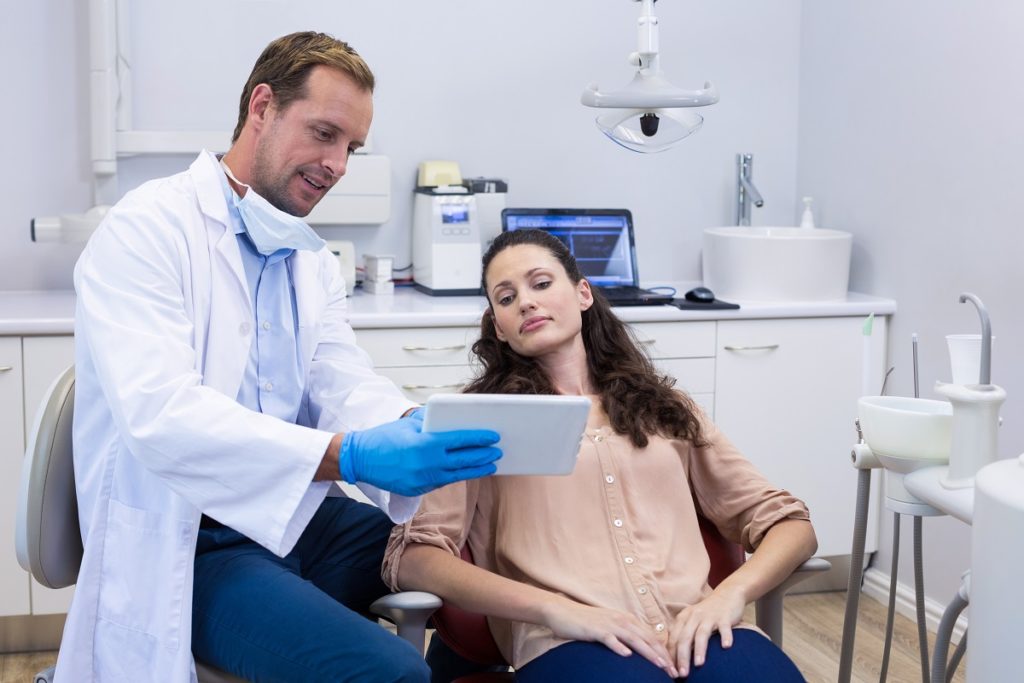 dentist checking up a client