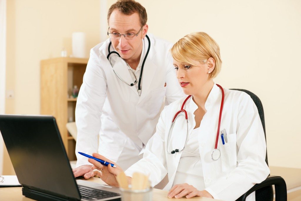 Doctors looking at laptop