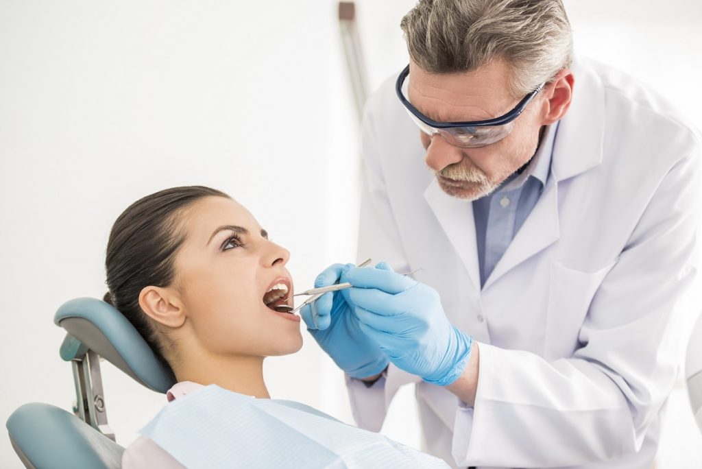 orthodontist attending to a patient