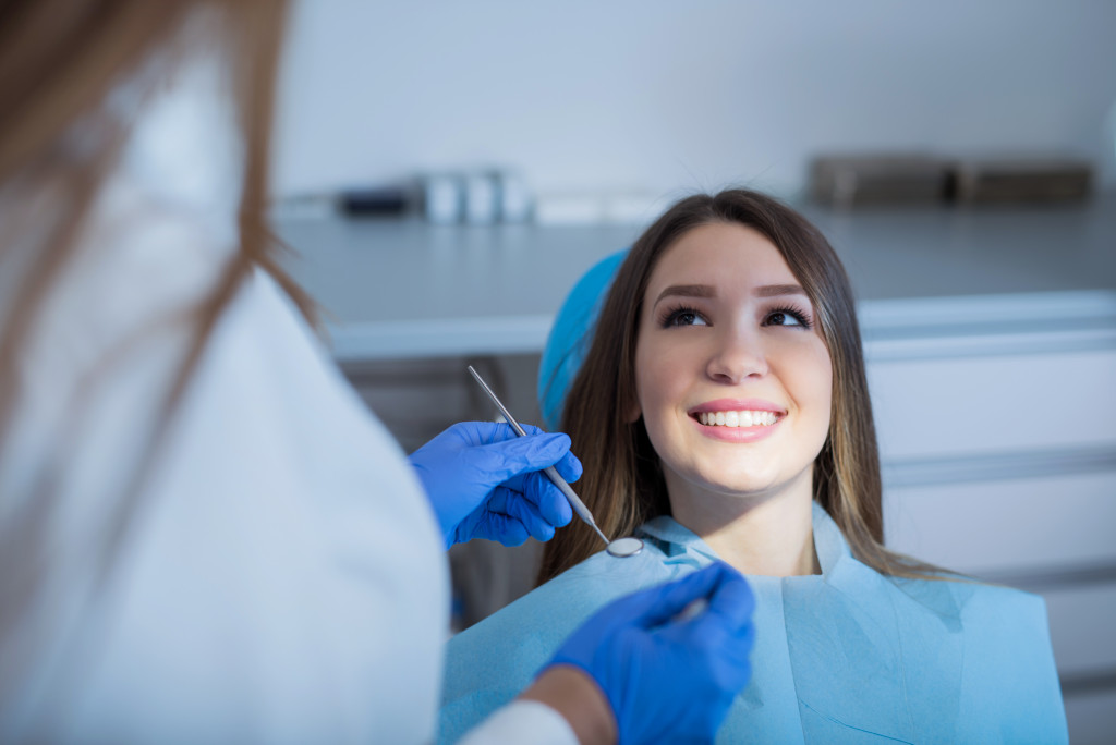 woman being checked up by her dentist