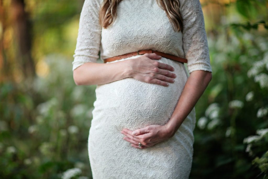 pregnant woman holding her tummy