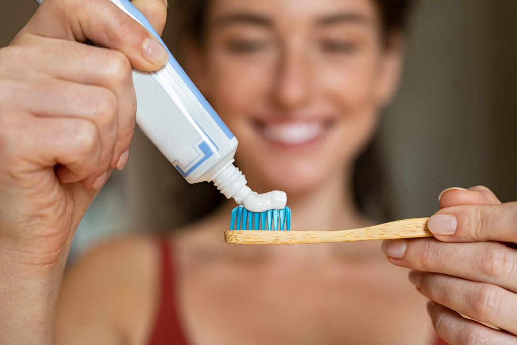 woman holding a toothbrush