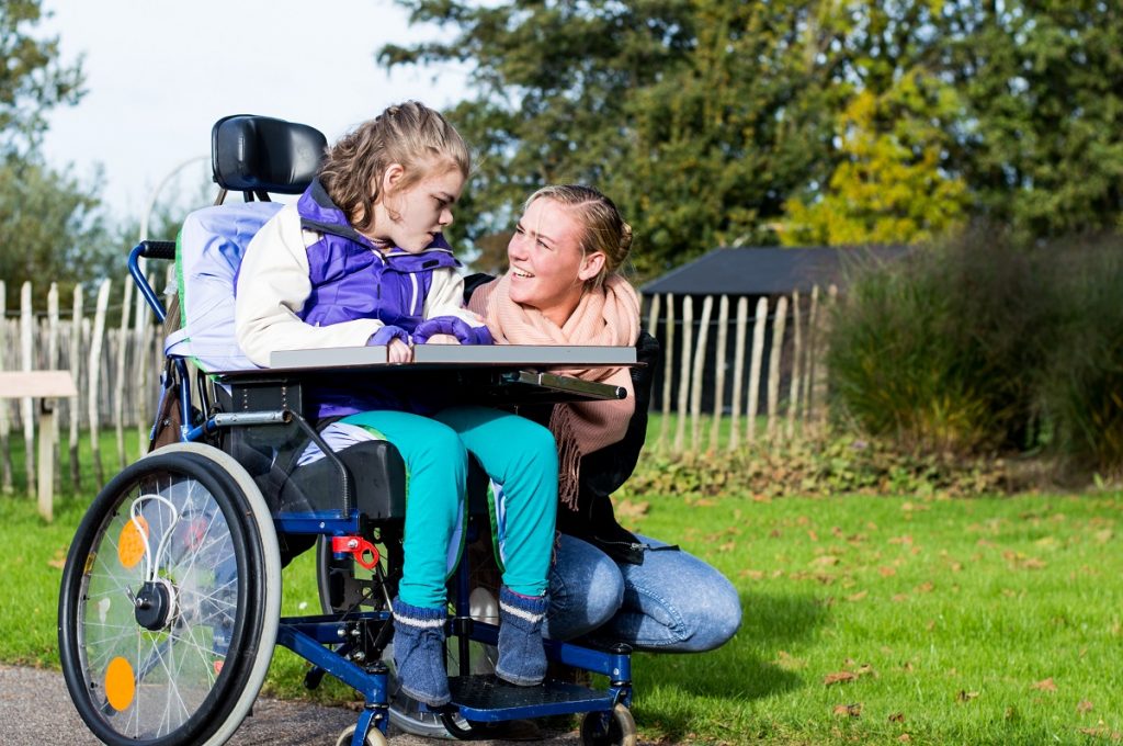 woman talking to a disabled child
